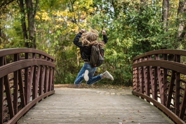 Character Strengths girl jumping on bridge